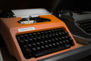 Eine nicht ganz so alte Schreibmaschine vom Hersteller Robotron. Sie hat ein Orange farbenes Chassie